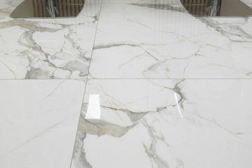 a pair of chairs sitting on top of a marble floor